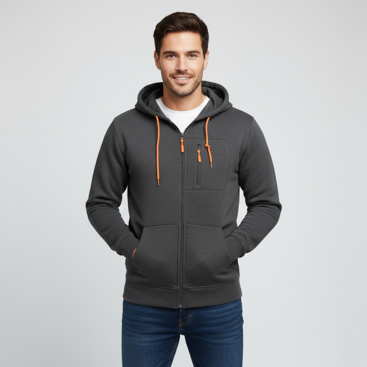 Man wearing a gray hoodie with orange zippers on a light gray background