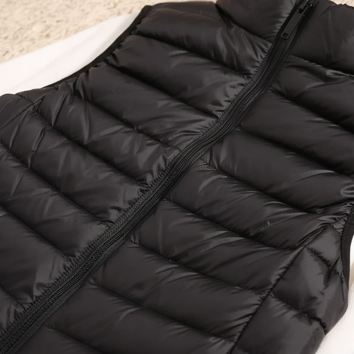 Black puffer vest on a light-colored surface