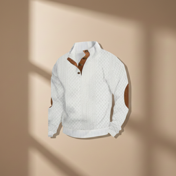 White knit sweater with brown accents on a beige background