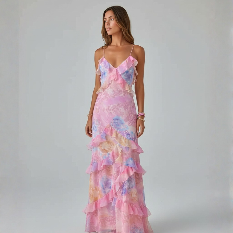 Woman wearing a colorful floral dress against a plain background