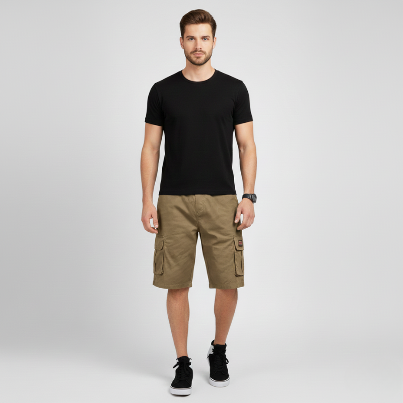 Man wearing a black t-shirt and brown cargo shorts on a light gray background