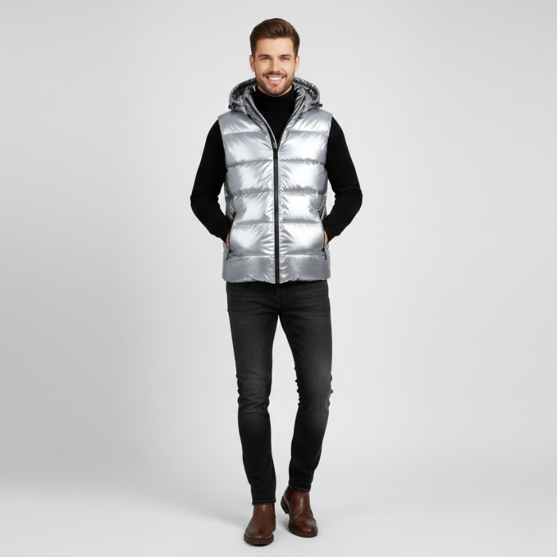 Man wearing a silver puffer vest on a white background