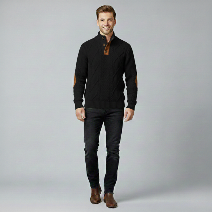 Man wearing a black sweater with brown accents on a gray background