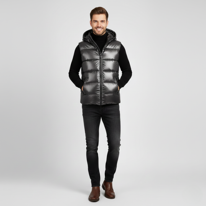 Man wearing a black puffer vest on a light gray background