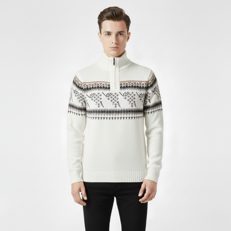 Man wearing a white sweater with a patterned design on a plain background