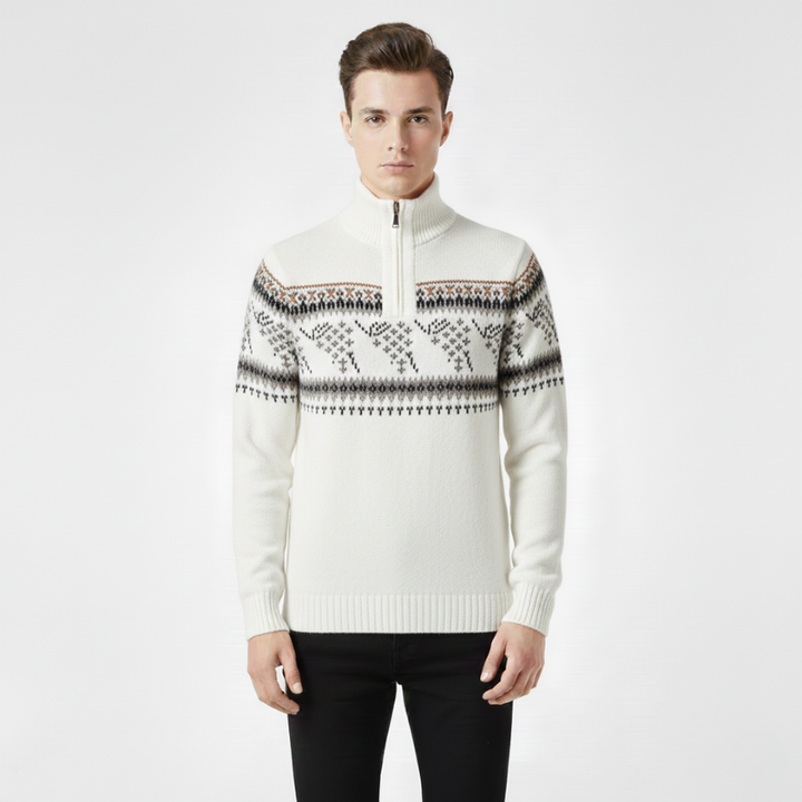 Man wearing a white sweater with a patterned design on a plain background