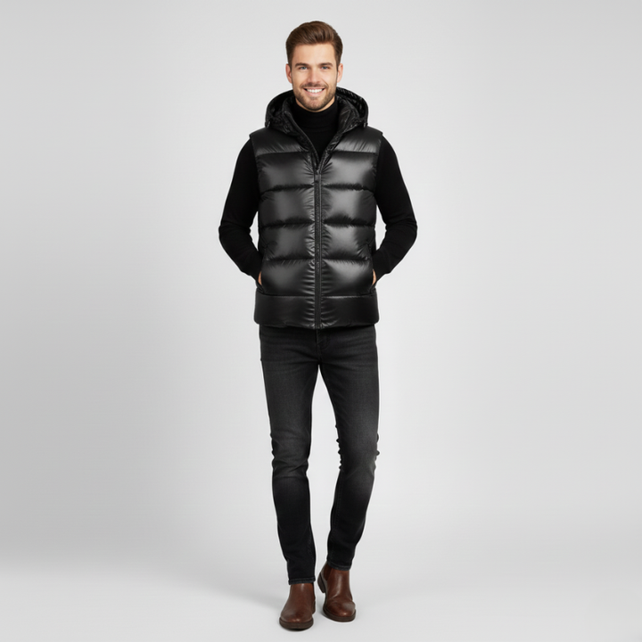 Man wearing a black puffer vest on a light gray background