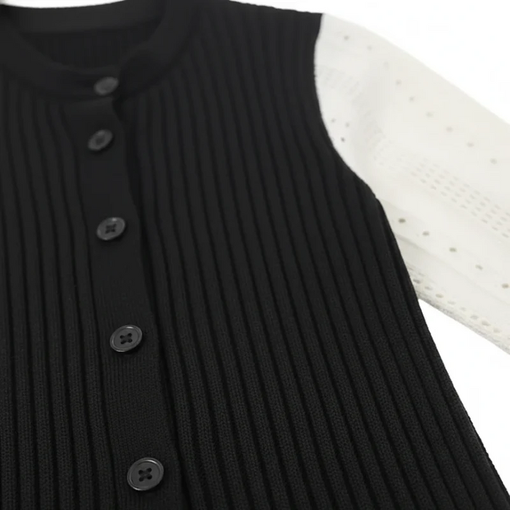 Black ribbed sweater with button details on a white background