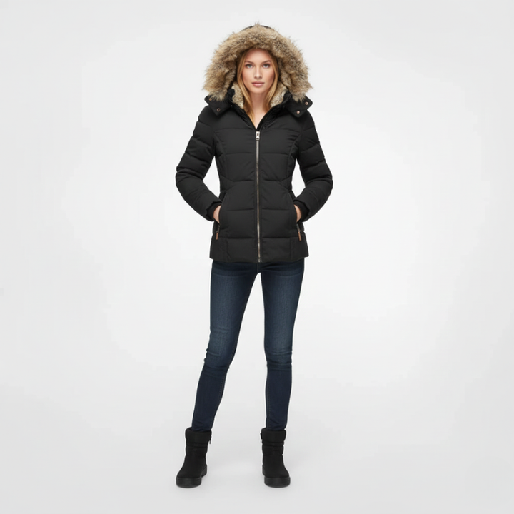 Person wearing a black puffer jacket with fur-lined hood on a white background