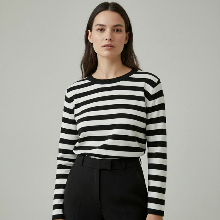 female model in black and white striped long-sleeve sweater giving minimal look