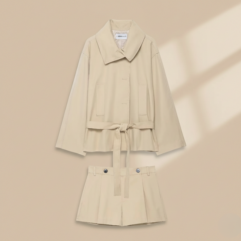 Beige trench coat with matching skirt on a beige background