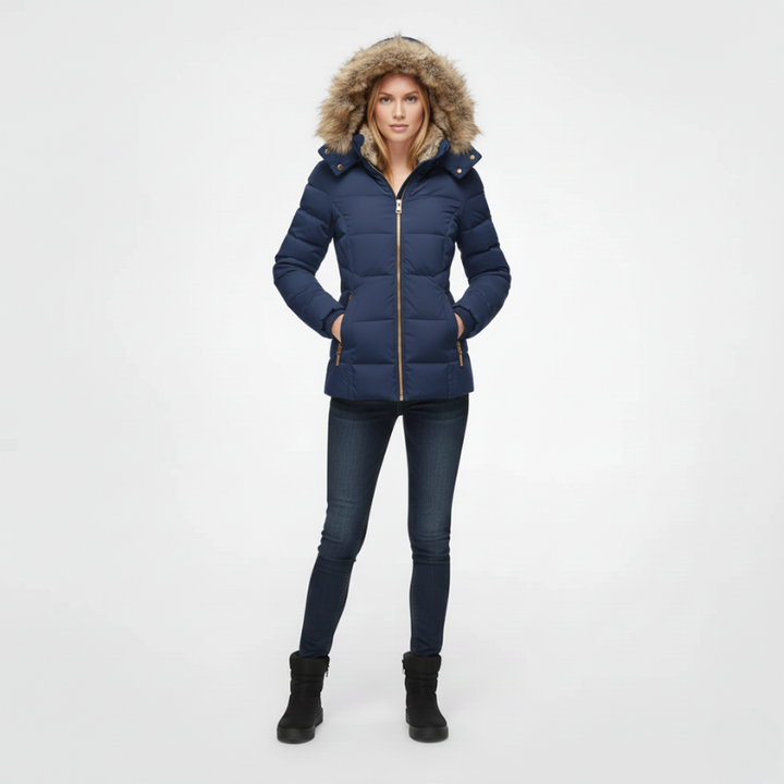 Woman wearing a blue puffer jacket with fur-lined hood on a white background