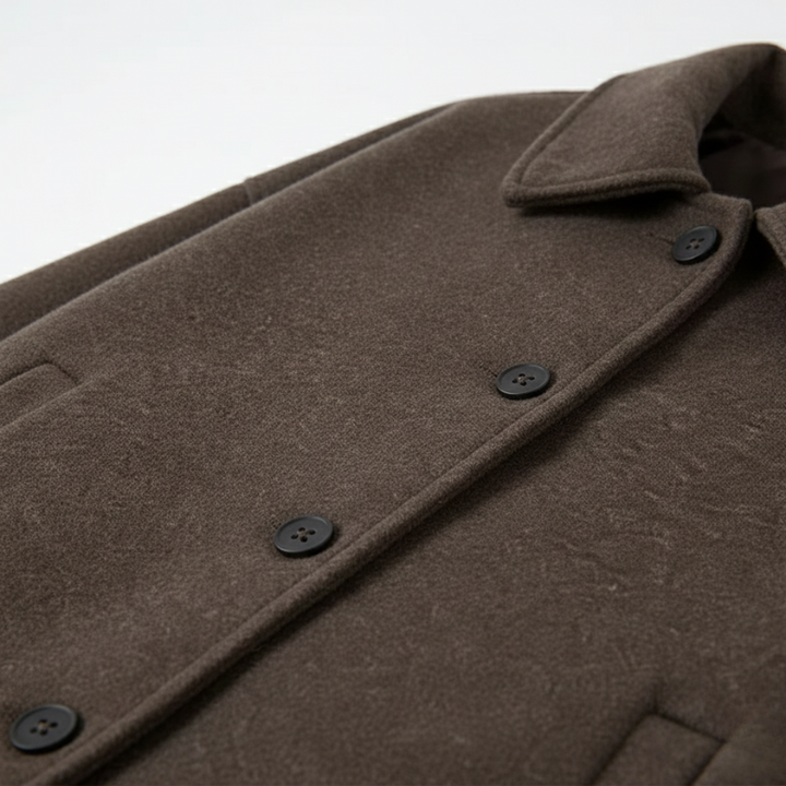 Close-up of a brown coat with buttons on a light gray background