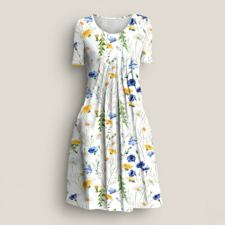 Close-up of floral dress fabric showing detailed botanical prints in blue, yellow, and green.