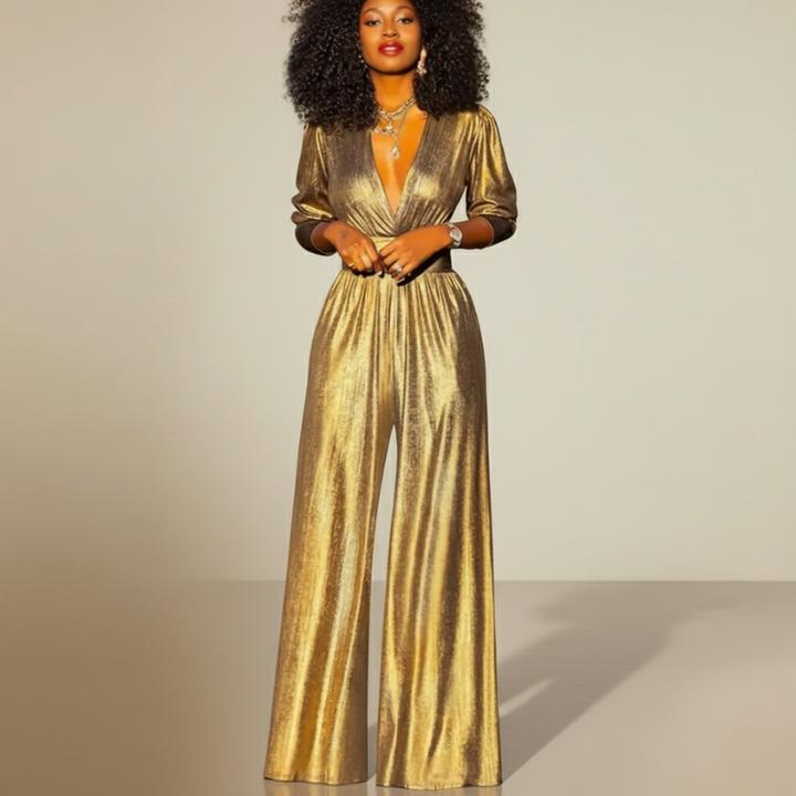 Flatlay of a gold satin wide-leg jumpsuit showing deep V-neck, cinched waist, and shimmering fabric.