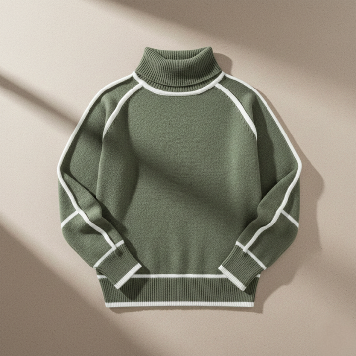 Flatlay of a green mock neck sweater with white contrast trim displayed on a neutral surface.