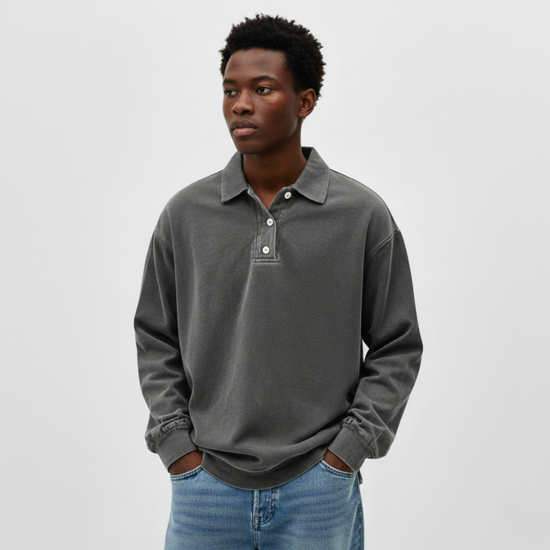 Flatlay of a green long-sleeve knit polo sweatshirt showing soft fabric texture and relaxed silhouette.