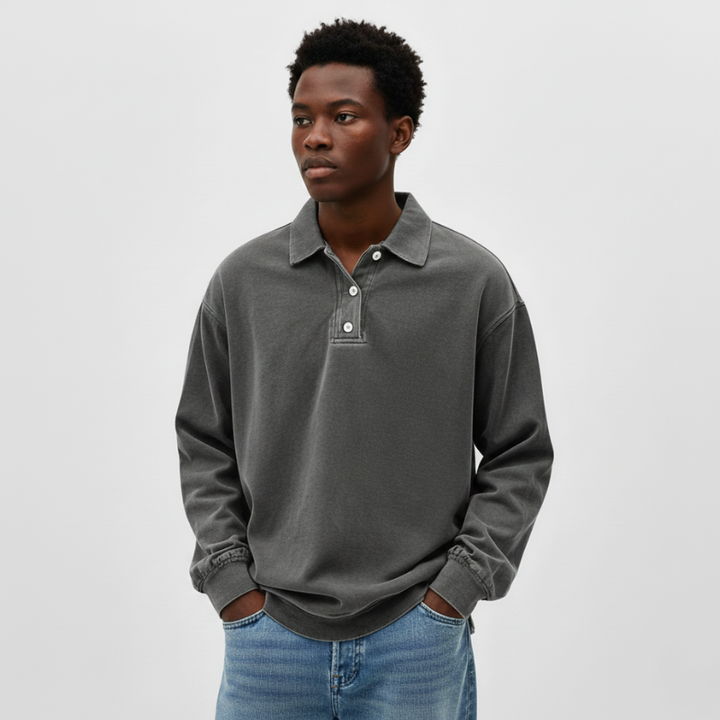 Flatlay of a green long-sleeve knit polo sweatshirt showing soft fabric texture and relaxed silhouette.