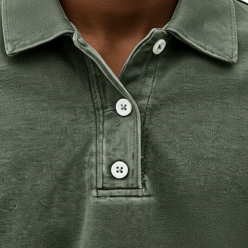 Close-up of a green knit polo sweatshirt showing the button placket, collar stitching, and textured fabric.