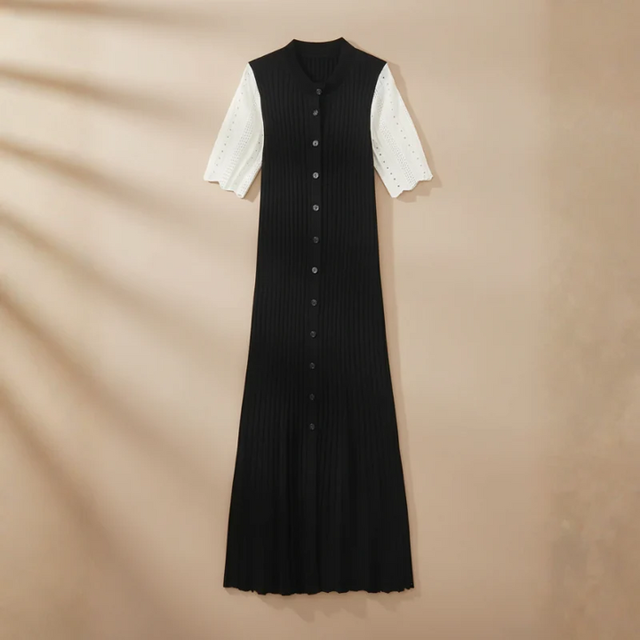 Black dress with white sleeves on a beige background