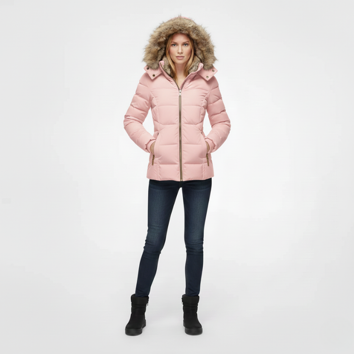 Person wearing a pink puffer jacket with fur hood on a white background
