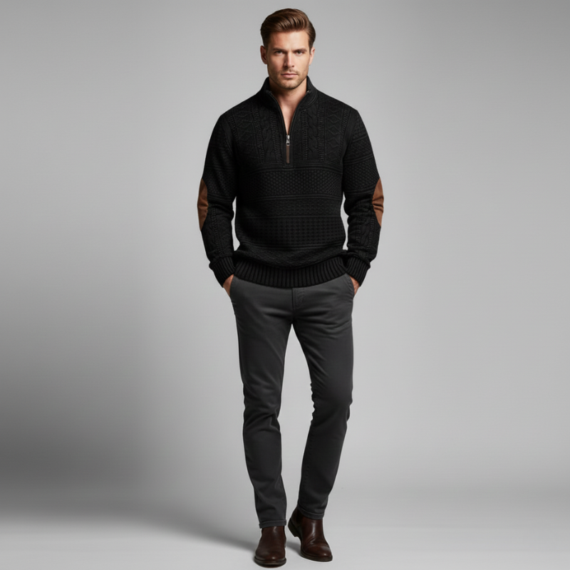 Full shot of a man wearing a black half-zip knit sweater styled with dark trousers.