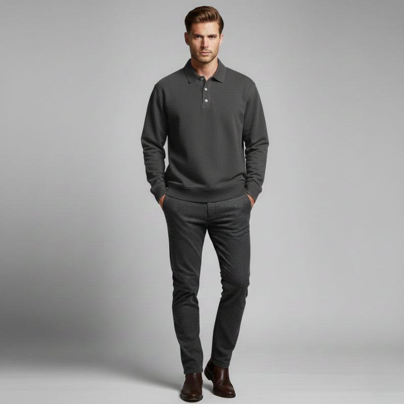 Model wearing a black button-collar knit pullover with hands in pockets, studio lighting.