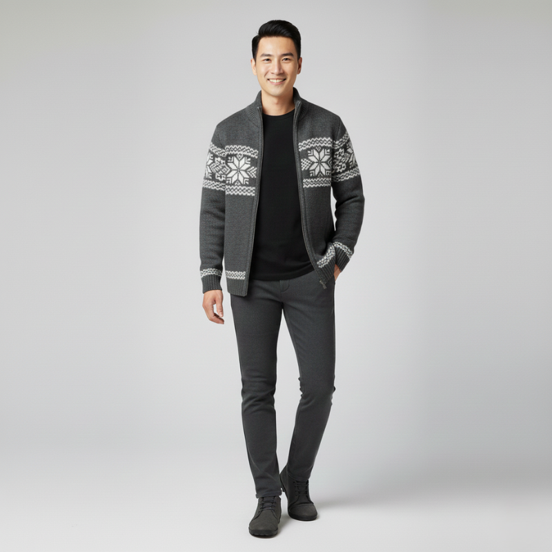 Man wearing a black knit zip-up sweater jacket styled with dark jeans in a studio setting.