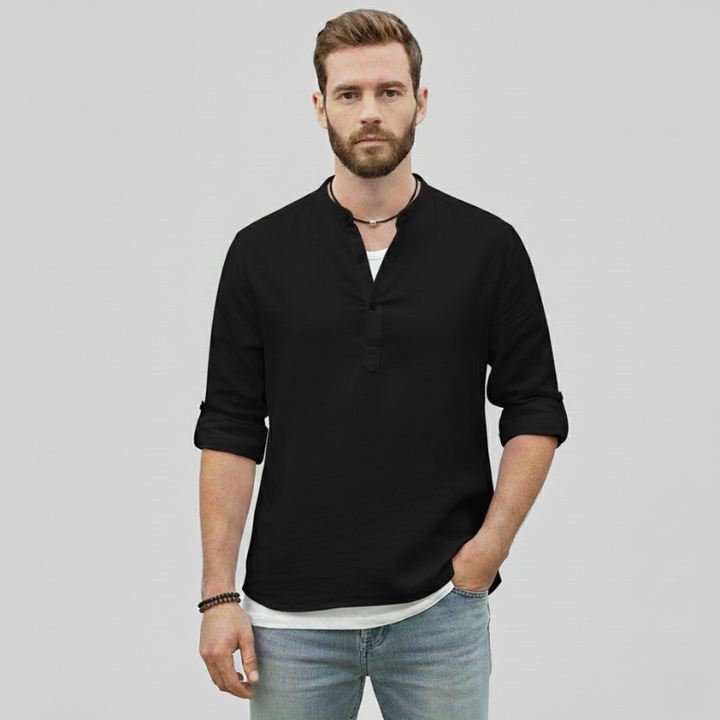 Man wearing a black linen long-sleeve casual shirt with a relaxed open-neck design.