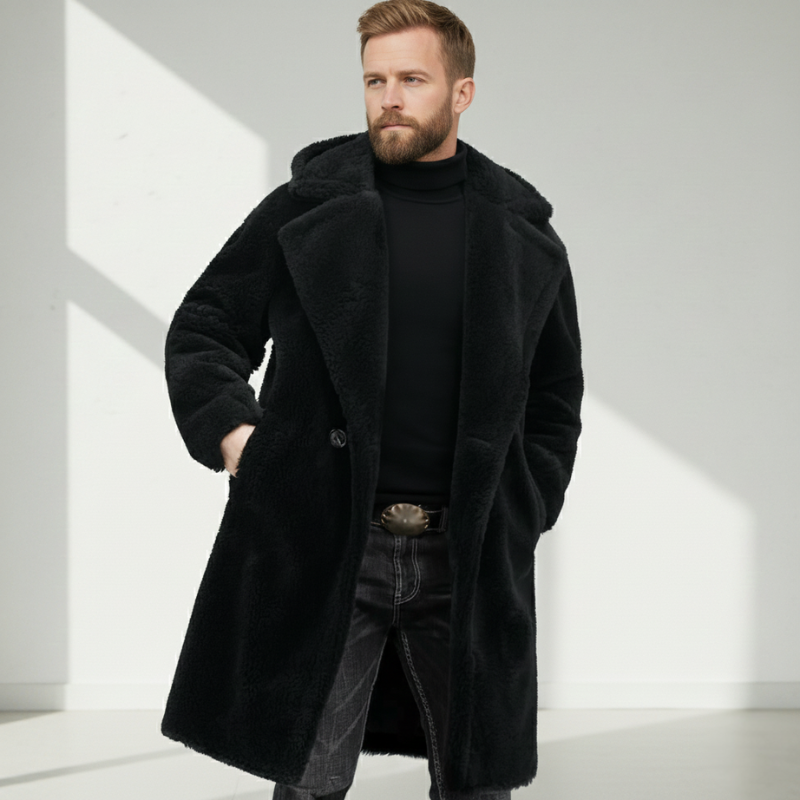 Side-view shot of a man wearing a black long overcoat styled with layered winter clothing.