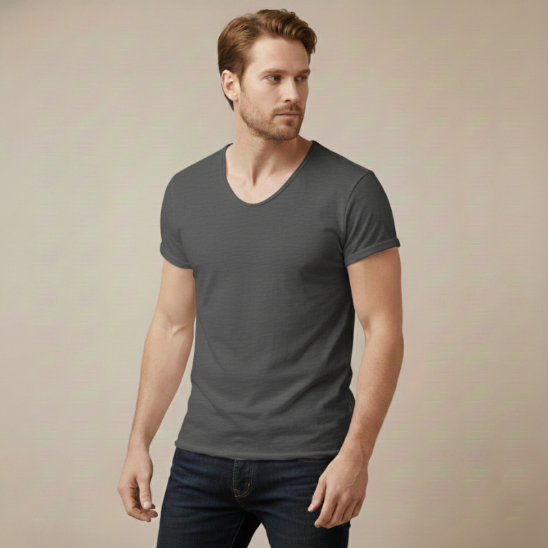 Man wearing a charcoal gray V-neck T-shirt with a modern fitted cut in soft room lighting.