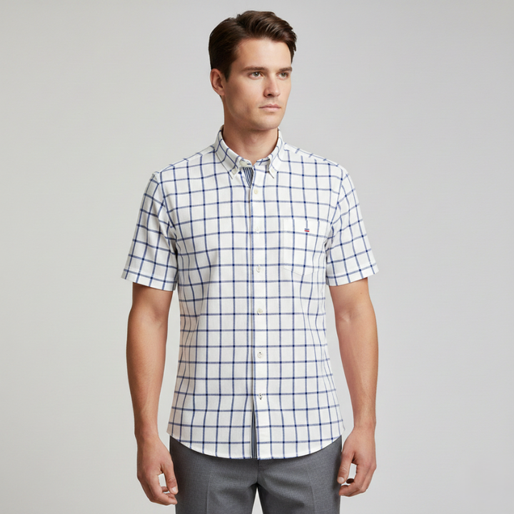 Male model in a blue and white check short-sleeve button-up shirt styled casually in studio lighting.