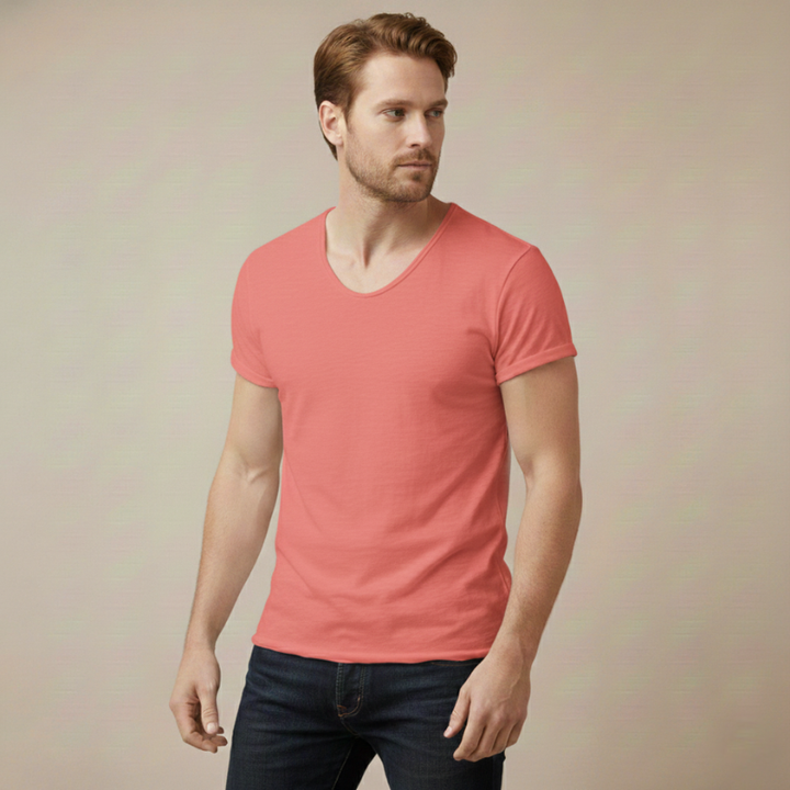 Model wearing a coral V-neck T-shirt featuring a slim fit and soft breathable fabric in a neutral studio.