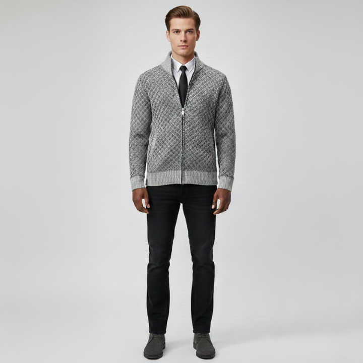 Male model wearing a light gray patterned zip cardigan with a clean tailored fit in soft studio lighting.