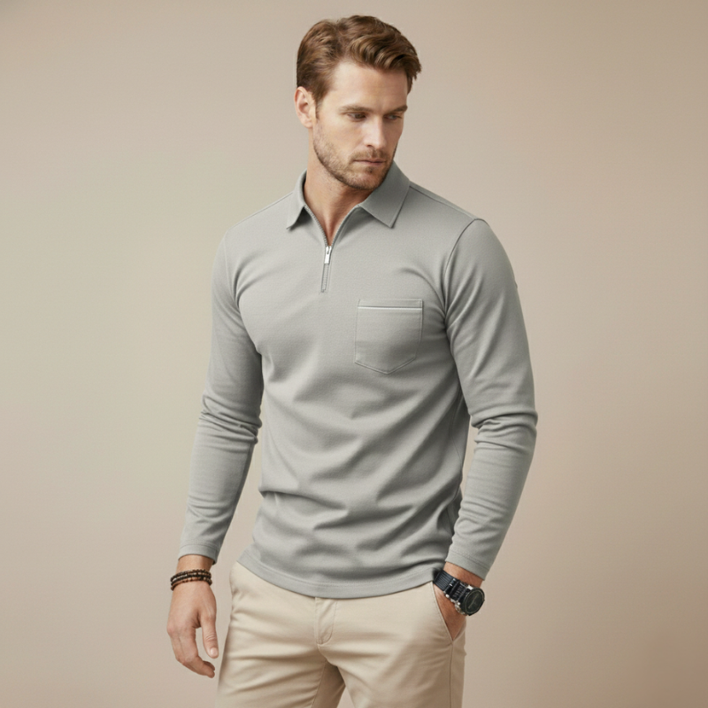 Man wearing a gray long-sleeve quarter-zip polo shirt with a clean minimal design in soft studio lighting.