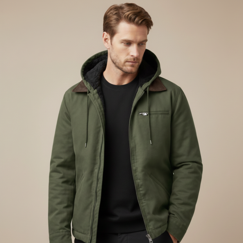 Man wearing a green hooded utility jacket with front pockets and a structured fit.