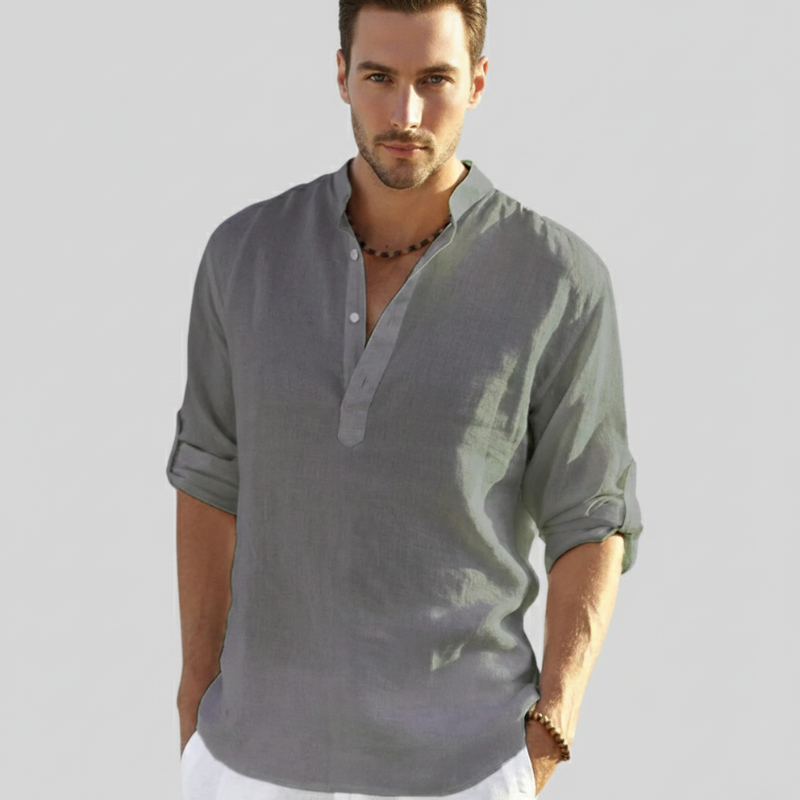 Male model in a soft grey linen shirt posing in natural light for a modern casual outfit.