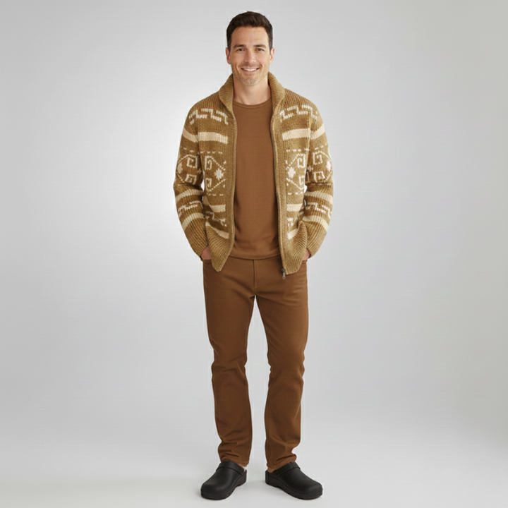 Male model standing in a patterned knit cardigan paired with jeans and casual shoes.