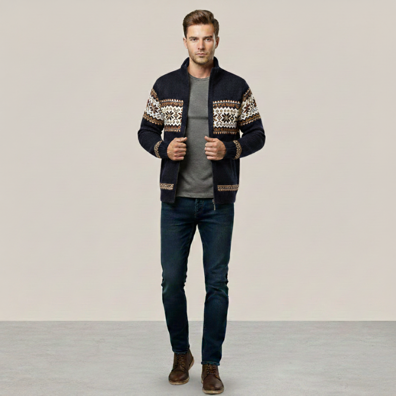 Man posing in a patterned knit cardigan jacket styled casually with dark jeans.