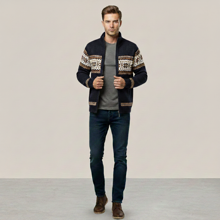 Man posing in a patterned knit cardigan jacket styled casually with dark jeans.