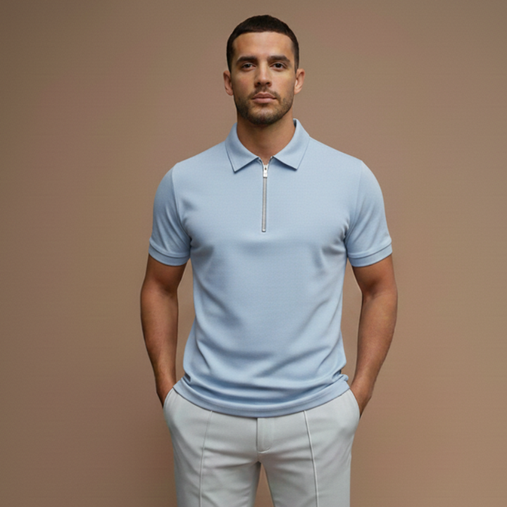 Male model in a light blue polo shirt featuring a tailored athletic fit in neutral studio lighting.