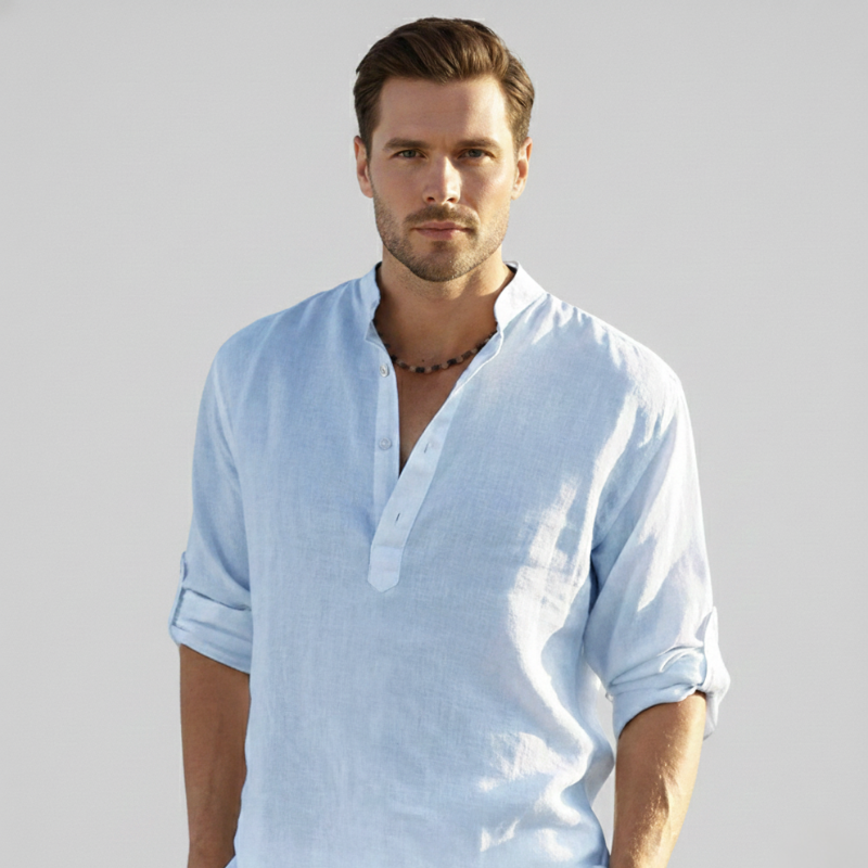 Model wearing a light blue linen shirt in soft daylight for a relaxed summer style.