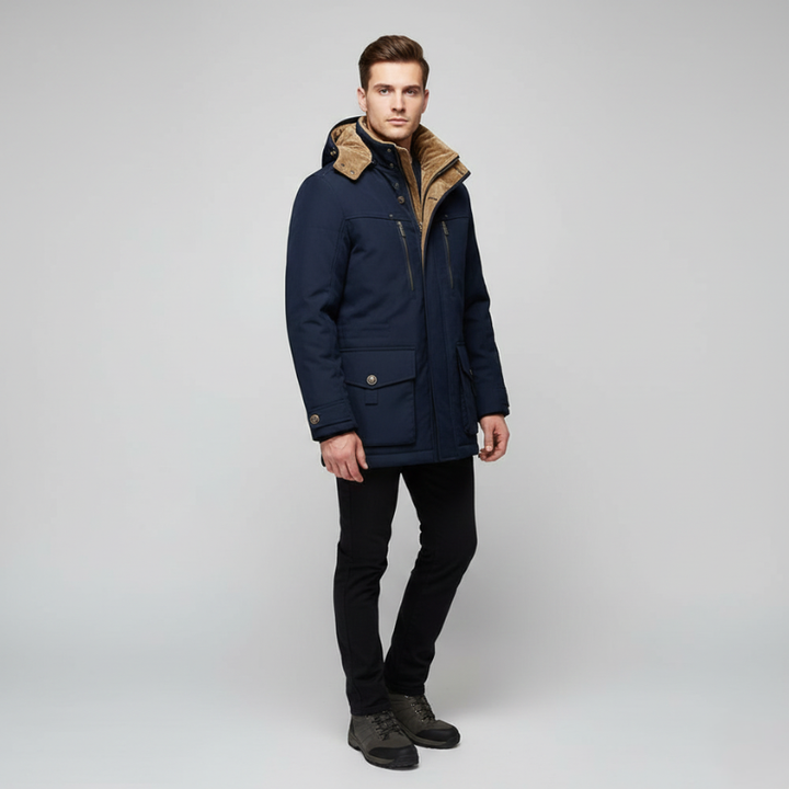 Male model wearing a navy blue hooded parka with a warm lining and zip-front closure in studio lighting.