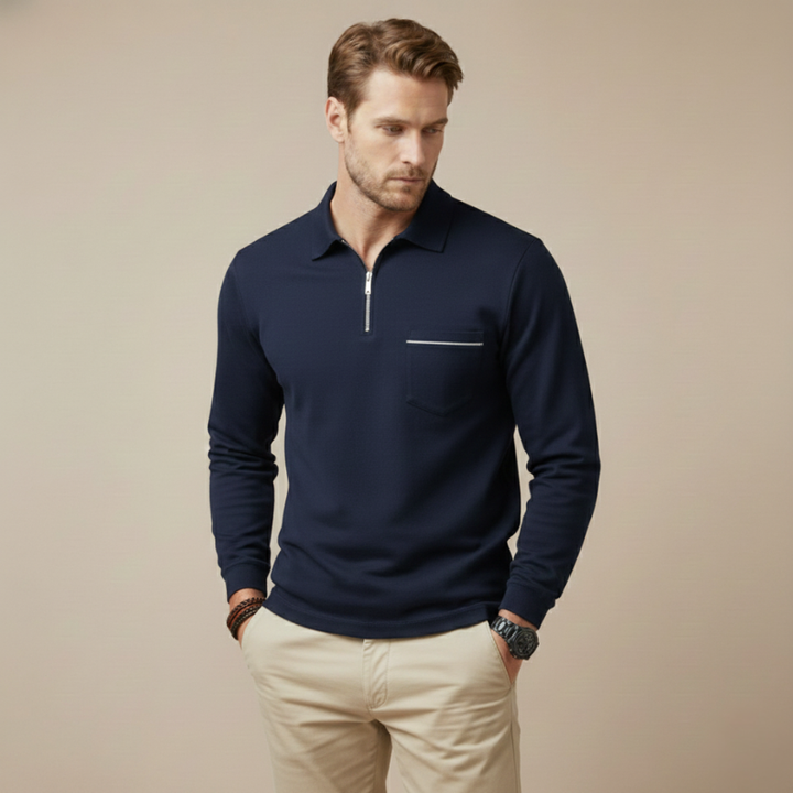 Male model in a navy long-sleeve quarter-zip polo shirt styled casually with beige pants.