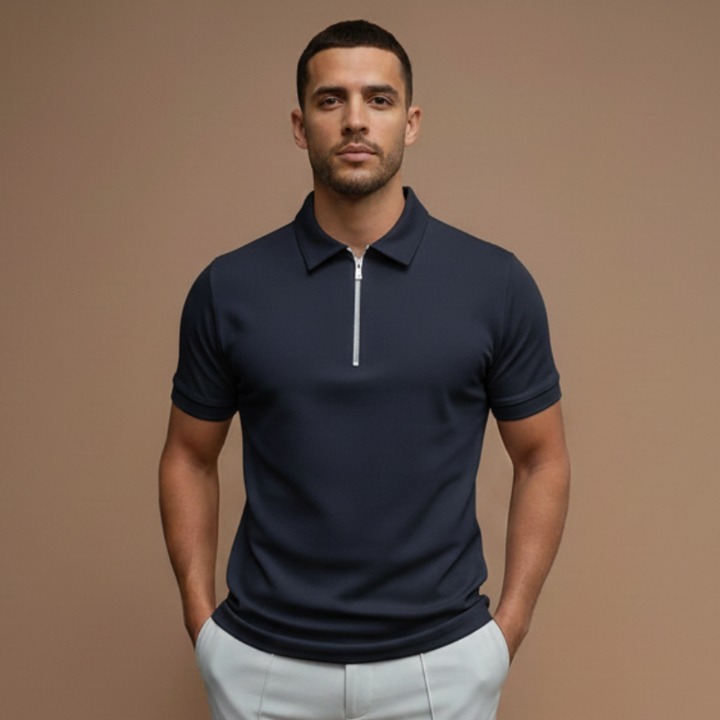 Man wearing a navy polo shirt with a structured collar and modern slim fit in a professional studio setting.