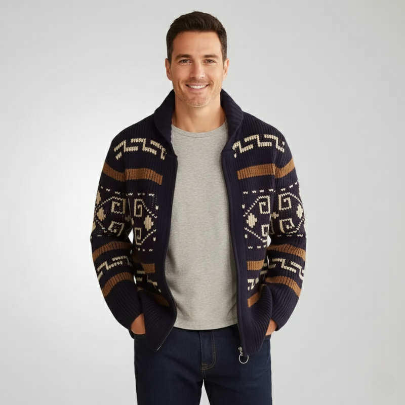 Man wearing a patterned knit cardigan jacket layered over a white t-shirt in a studio setting.