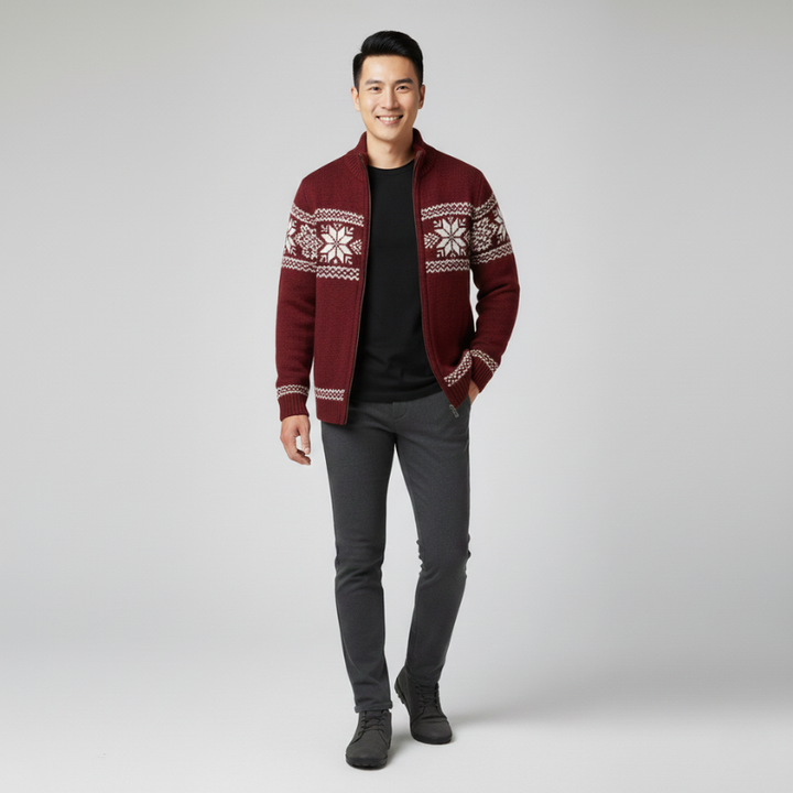 Man standing in a burgundy patterned knit zip sweater styled with dark pants.