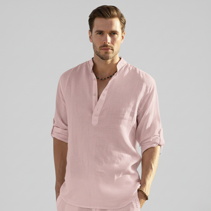 Model wearing a light pink linen button-down shirt for a soft pastel summer style look.