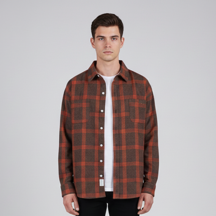Male model wearing a red plaid button-up shirt styled casually for everyday fall or winter outfits.