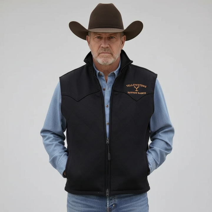 The model wears a black western vest with gold embroidery, a stand-up collar and a zipper over a denim shirt in the studio.